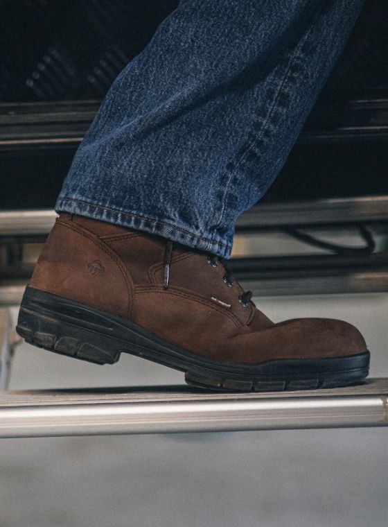 a person's foot stepping on a metal step